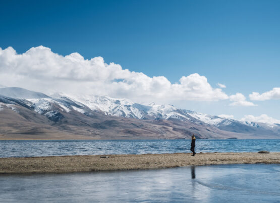 women at Pangong lake and mountain in Leh Ladakh, India women at Pangong lake and mountain in Leh Ladakh, India
