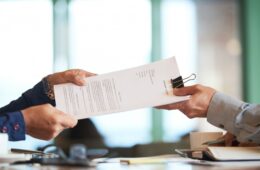 closeup-hands-passing-contract-unrecognizable-businessman-min