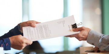 closeup-hands-passing-contract-unrecognizable-businessman-min